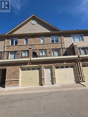 Mississauga (Churchill Meadows) house for rent - A two-story residential building with a balcony on the second floor.