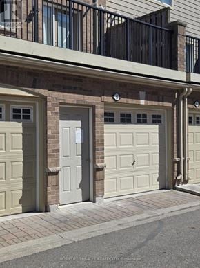 Mississauga (Churchill Meadows) house for rent - A row of garage doors in front of a building.