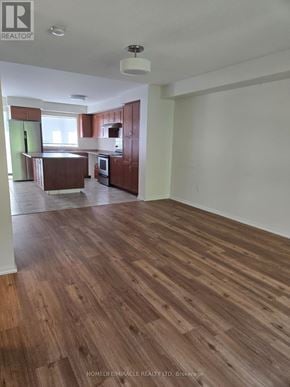Mississauga (Churchill Meadows) house for rent - A spacious room with wooden flooring and white walls.