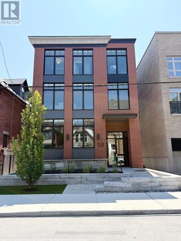 Ottawa apartment for rent - A modern two story building with a red brick facade and large windows.
