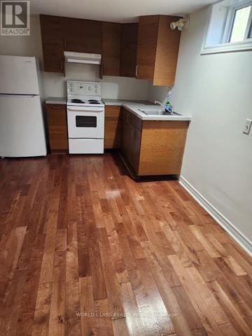 Richmond Hill (Crosby) apartment for rent - A kitchen with a white fridge and a white stove top oven.