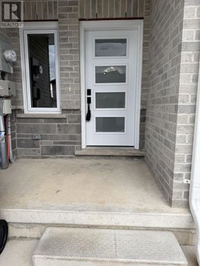 St. Marys townhouse for rent - A white door with a glass panel is on a brick wall.