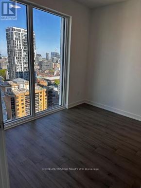Toronto (Church-Yonge Corridor) condo for rent - A room with a view of the city through a large window.