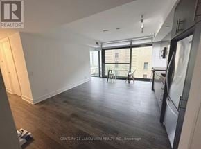 Toronto (Church-Yonge Corridor) condo for rent - A spacious room with wooden floors and a large window.