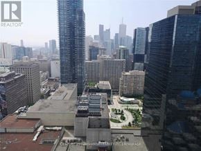 Toronto (Bay Street Corridor) condo for rent - A cityscape with a mix of modern and older buildings, with a large park area in the foreground.