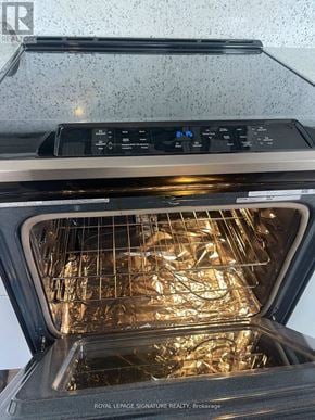 Markham (Royal Orchard) condo for rent - An open oven with the door open showing the interior and rack.