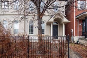 Mississauga (Churchill Meadows) townhouse for rent - A white building with a black door and windows.