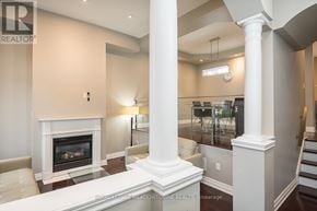 Mississauga (Churchill Meadows) townhouse for rent - A spacious living room with a fireplace and a staircase.