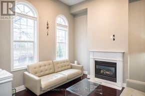 Mississauga (Churchill Meadows) townhouse for rent - A living room with a white couch and a fireplace.
