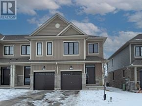 Zorra (Thamesford) townhouse for rent - A large, two-story house with a garage is situated in a residential area.
