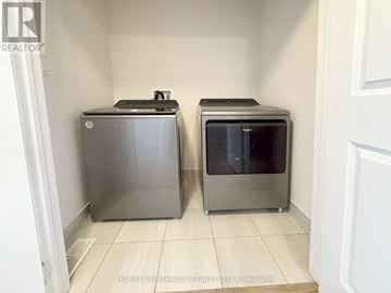 Zorra (Thamesford) townhouse for rent - A kitchen with two microwaves and a fridge.
