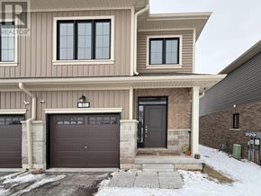 Zorra (Thamesford) townhouse for rent - A two-story house with a garage and a brown door.