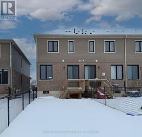 Zorra (Thamesford) townhouse for rent - A building with the text "HOMELIFE/MIRACLE REALTY LTD, Brokerage" on it.