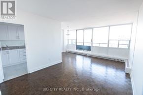 Toronto (Playter Estates-Danforth) condo for rent - A spacious room with wood flooring and large windows.
