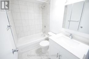 Toronto (Playter Estates-Danforth) condo for rent - A white bathroom with a toilet, sink, and bathtub.