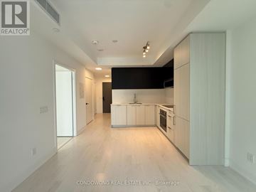Toronto (Church-Yonge Corridor) condo for rent - A spacious kitchen with white cabinets and a black countertop.