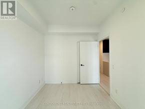 Toronto (Church-Yonge Corridor) condo for rent - A white door is in the middle of a room with a wood floor.
