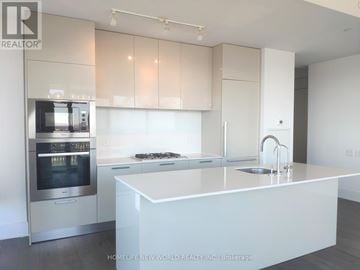 Toronto (Church-Yonge Corridor) condo for rent - A modern kitchen with a stainless steel oven and white countertops.