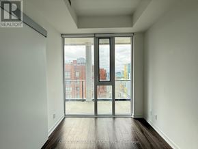 Toronto (Bay Street Corridor) condo for rent - A room with a sliding door leading to a balcony.
