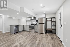 Haldimand apartment for rent - A kitchen with wooden floors and stainless steel appliances.