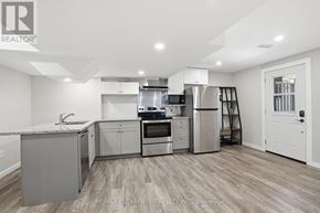 Haldimand apartment for rent - A modern kitchen with stainless steel appliances and wooden flooring.