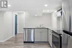 Haldimand apartment for rent - A modern kitchen with stainless steel appliances and white cabinets.