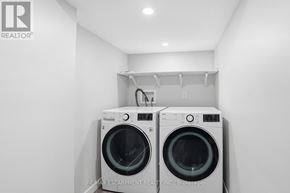 Haldimand apartment for rent - Two white front loading washing machines in a laundry room.
