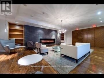 Toronto (Henry Farm) condo for rent - A modern living room with a white sofa and a glass coffee table.
