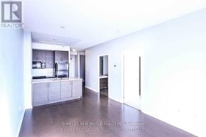 Toronto (Henry Farm) condo for rent - A spacious kitchen with white cabinets and a refrigerator.