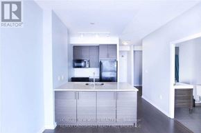 Toronto (Henry Farm) condo for rent - A modern kitchen with a refrigerator, sink, and cabinets.