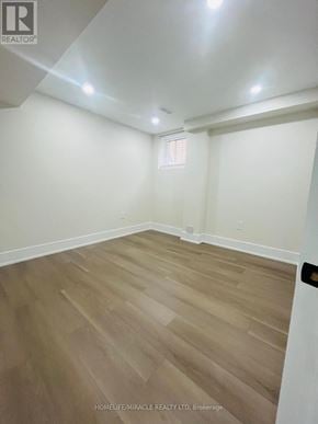 Ajax (Central) apartment for rent - A room with wooden flooring and white walls.