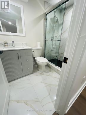 Ajax (Central) apartment for rent - A bathroom with a toilet, sink, and shower.