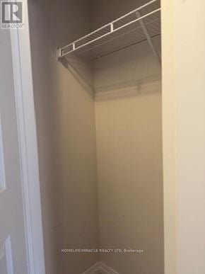 Brantford townhouse for rent - A white closet with a shelf and a sign that says "Realtor".