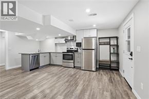 Caledonia apartment for rent - A well-lit kitchen with stainless steel appliances and wooden flooring.