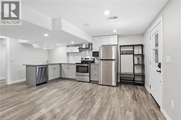 Caledonia apartment for rent - A well-lit kitchen with stainless steel appliances and wooden flooring.