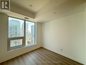 Toronto (Church-Yonge Corridor) condo for rent - A room with a large window overlooking a cityscape.