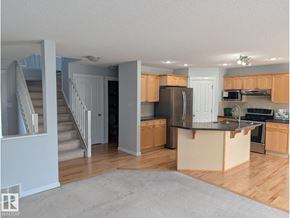 Edmonton apartment for rent - A kitchen with wooden floors and a black countertop.