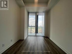 Toronto (Moss Park) condo for rent - A room with a sliding glass door leading to a balcony.