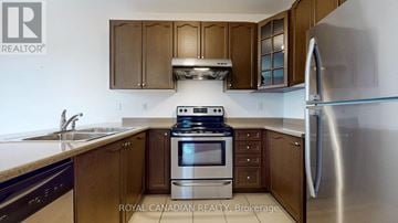 Whitchurch-Stouffville (Stouffville) apartment for rent - A kitchen with a stove top oven and a refrigerator.