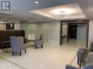 Brampton (Sandringham-Wellington) townhouse for rent - A living room with a brown couch and grey armchairs.