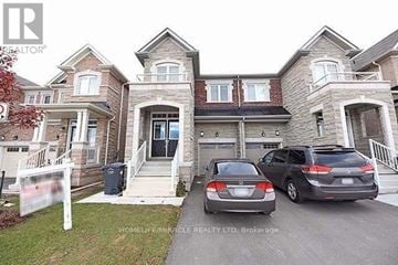 Brampton (Northwest Brampton) apartment for rent - A two-story house with a car parked in front.