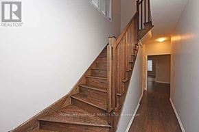 Brampton (Northwest Brampton) apartment for rent - A wooden staircase with a sign on it that says HomeEmmacrle Realty LTD Brokerage.