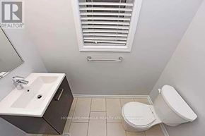 Brampton (Northwest Brampton) apartment for rent - A white toilet sits next to a sink in a small bathroom.