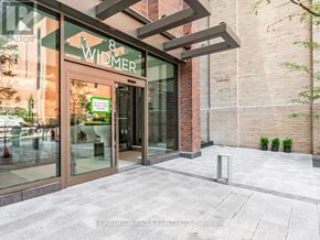 Toronto (Waterfront Communities) condo for rent - The entrance to a building with a glass door and a sign that reads "WIDMER".