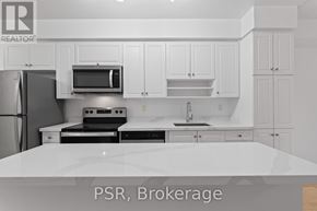 Toronto (Waterfront Communities) condo for rent - A kitchen with white cabinets and appliances.
