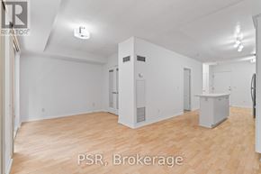 Toronto (Waterfront Communities) condo for rent - A room with wooden flooring and white walls, with a kitchenette in the corner.