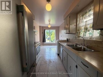 Toronto (Agincourt North) apartment for rent - A kitchen with a refrigerator, sink, and cabinets.