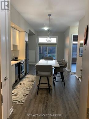 Burlington (Lasalle) condo for rent - A dining area with a table and chairs in a modern kitchen.