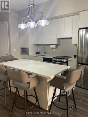 Burlington (Lasalle) condo for rent - A modern kitchen with a dining table and chairs.