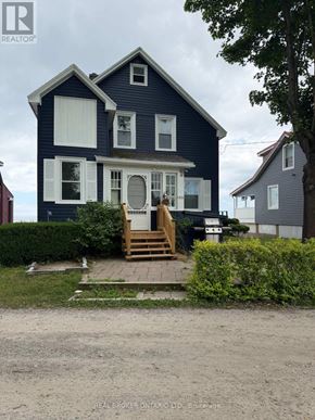 Wainfleet (Lakeshore) apartment for rent - A blue house with a white door and windows is for sale.